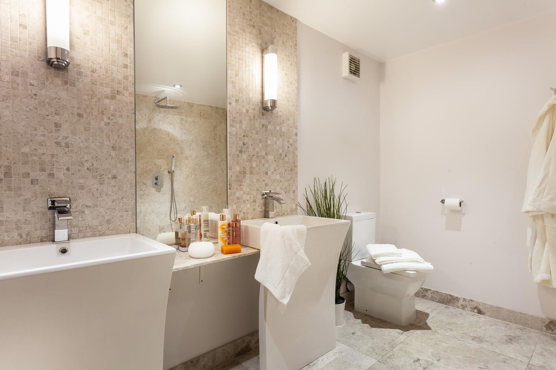 The ensuite from bedroom 4 has designer Jack and Jill washbasins.