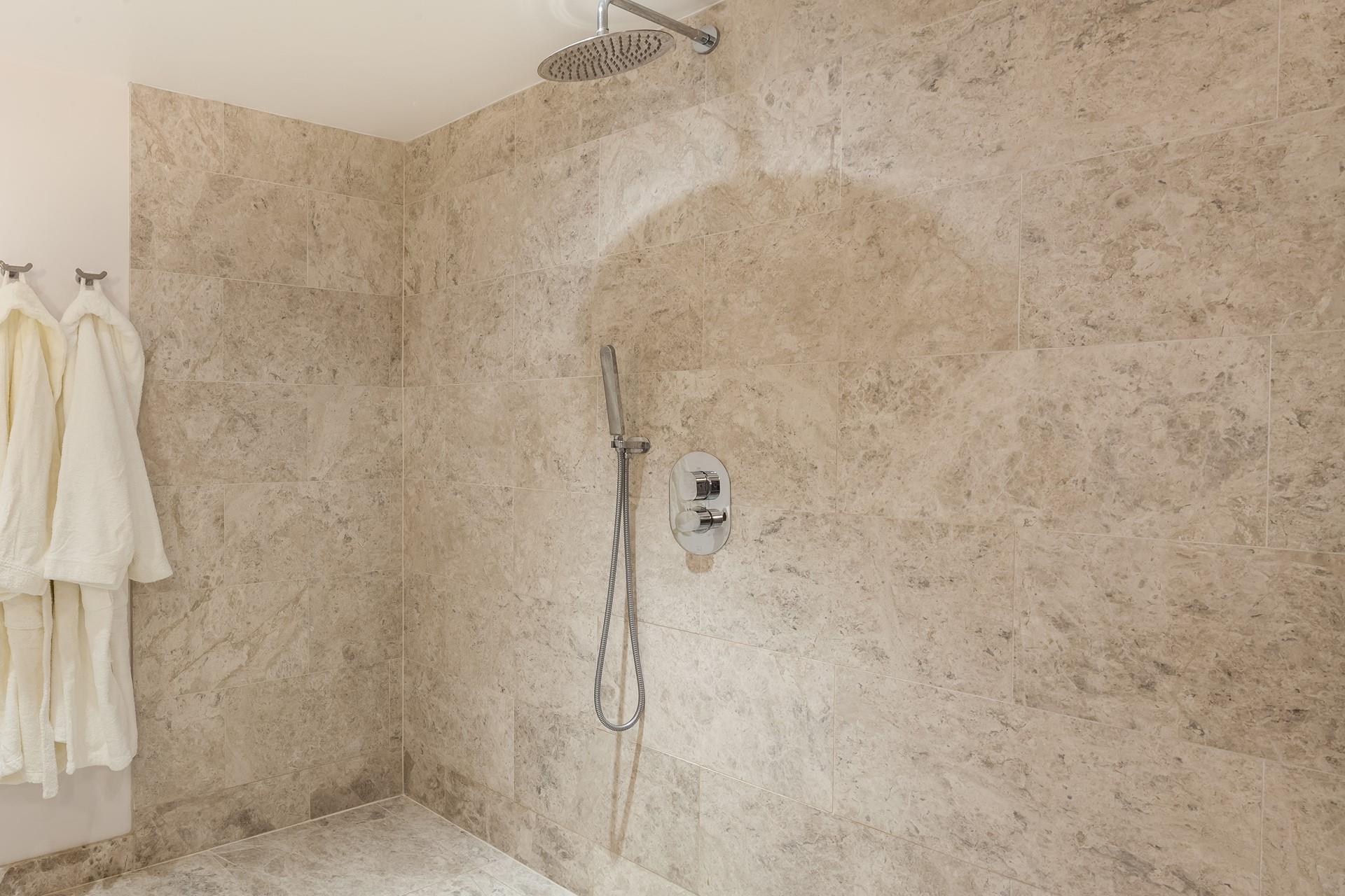 Beautiful tiling in the wetroom creates the ultimate spa experience.