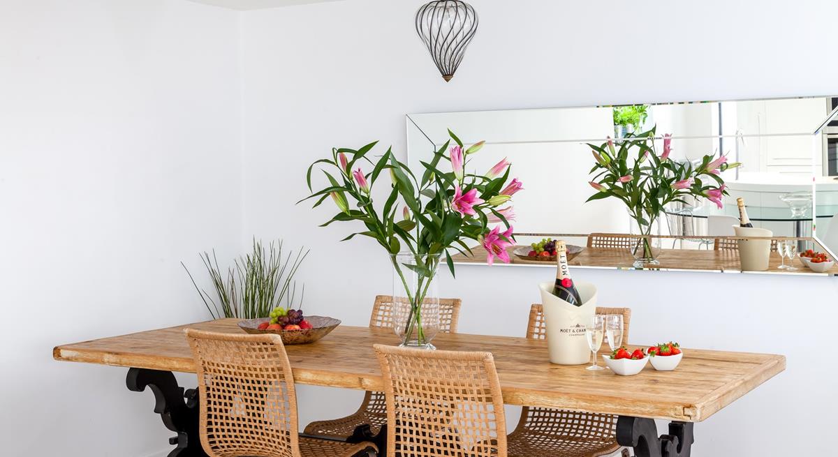 Gather around the stylish dining table and tuck into a tasty feast.