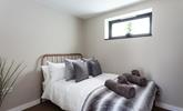 Bedroom 2 has a contemporary grey decor for a calming space to relax. - Thumbnail Image
