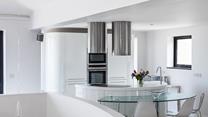 Curved contemporary lines have created a fantastic kitchen area in the living space, which captures pure light and angles.