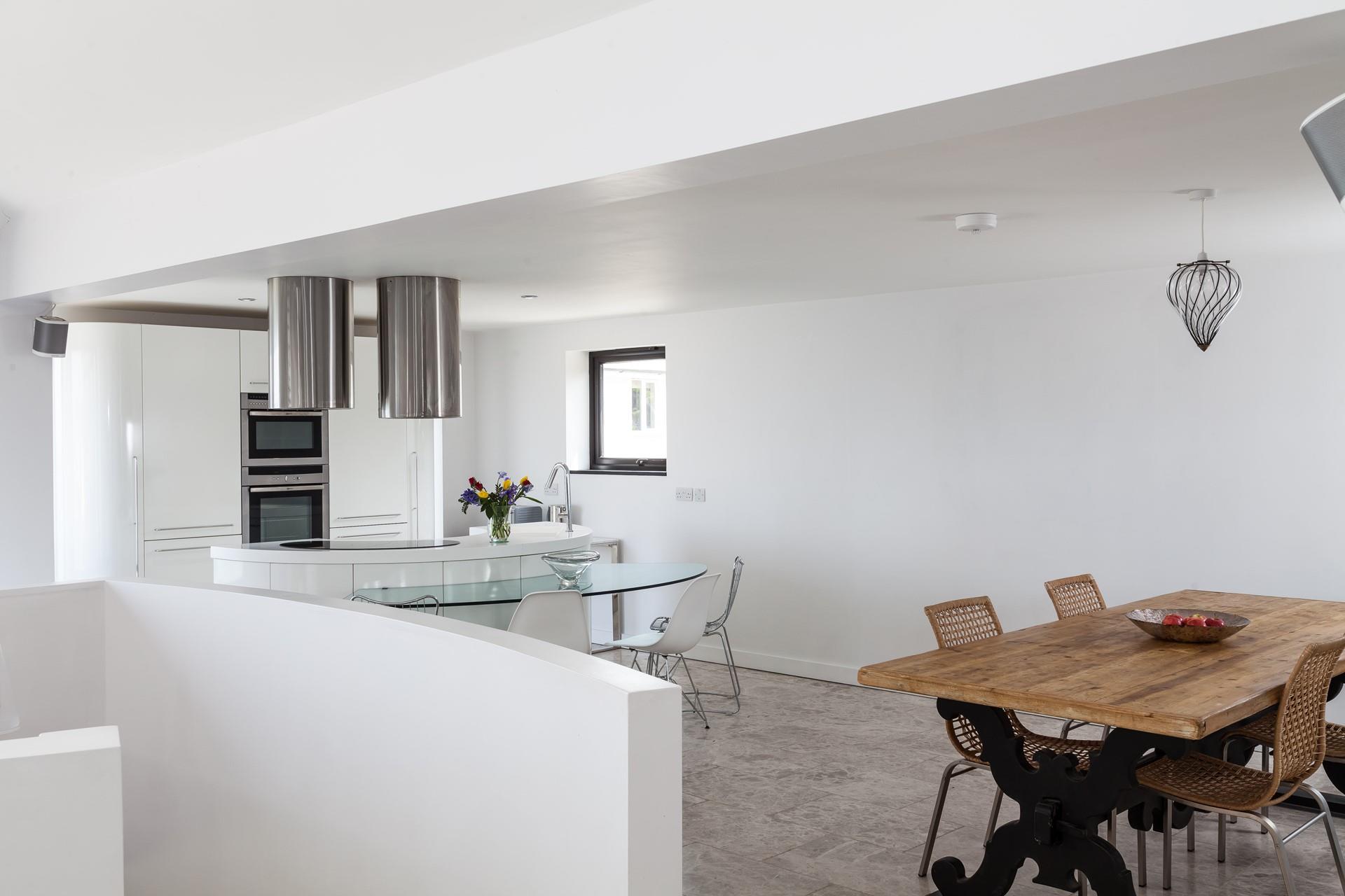 The rustic dining table compliments the contemporary feel of Higher Carthew.