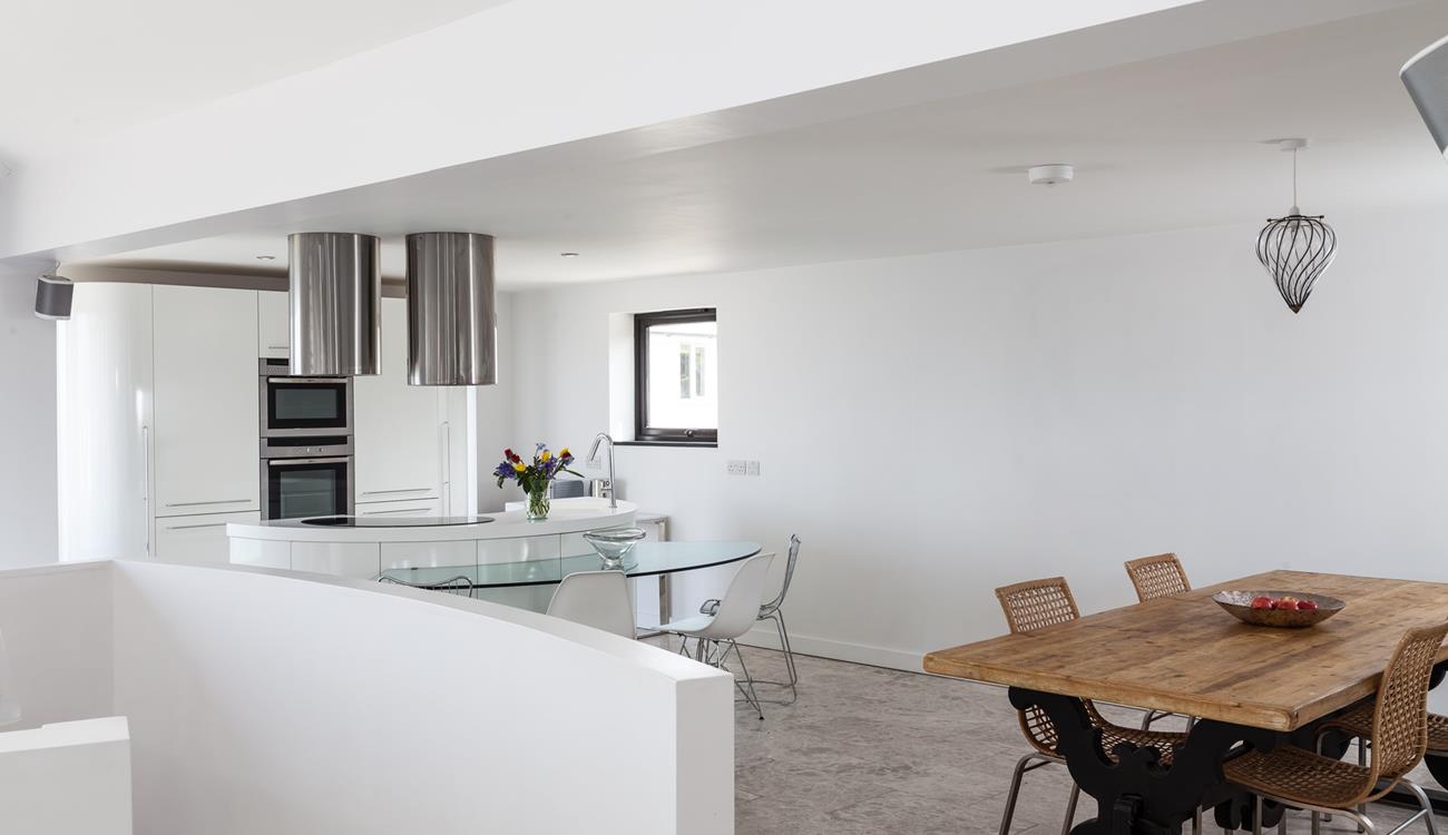 The rustic dining table compliments the contemporary feel of Higher Carthew.