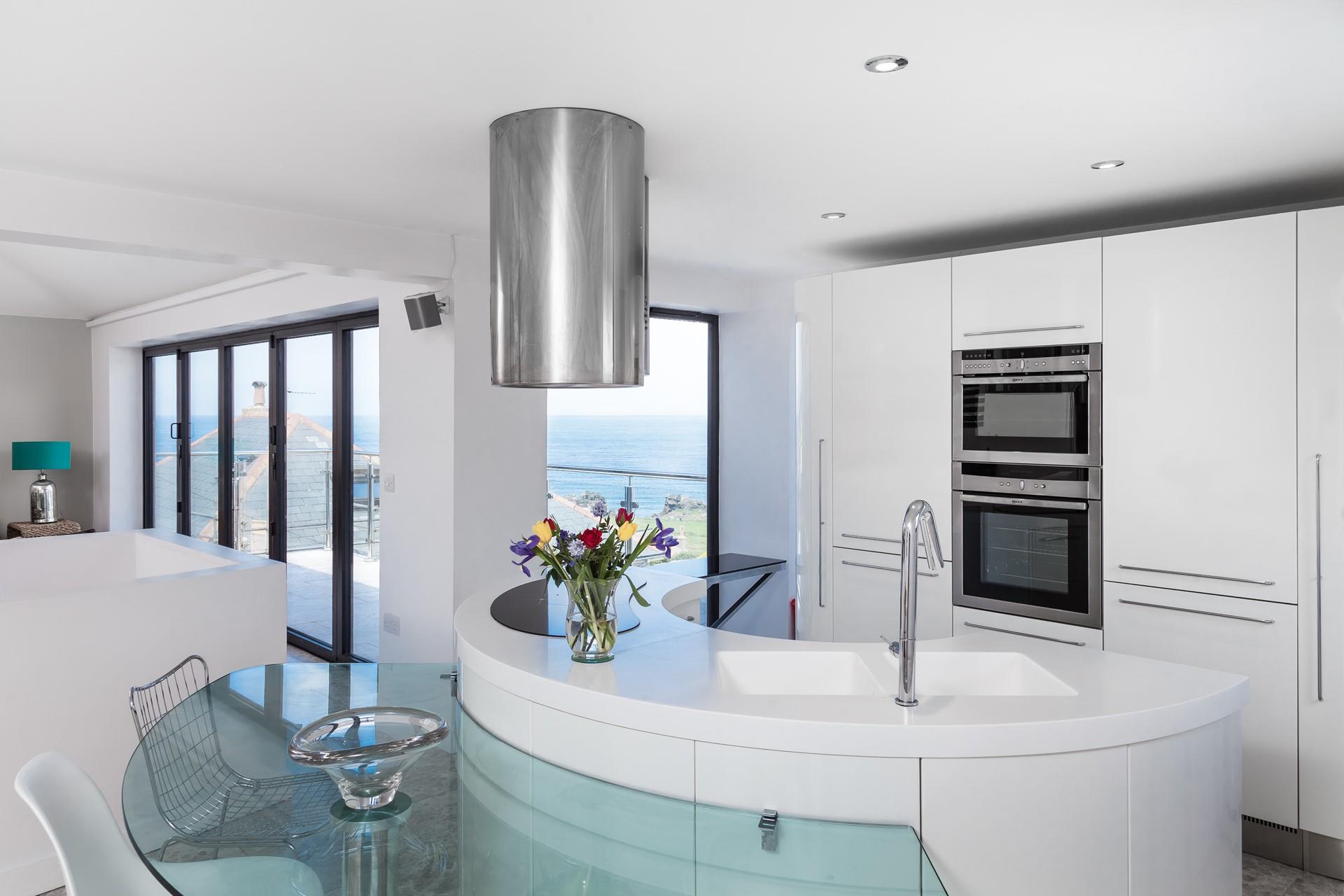 The kitchen area is sleek and contemporary, a dream to cook meals in.