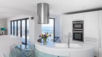 The kitchen area is sleek and contemporary, a dream to cook meals in.