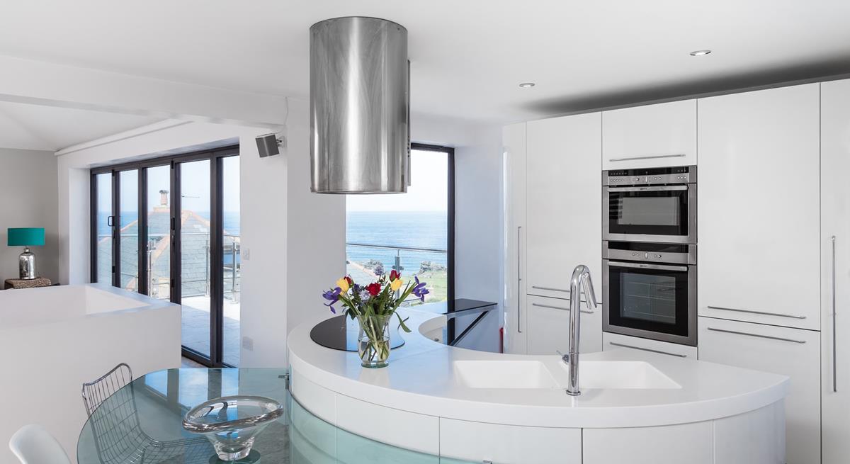 The kitchen area is sleek and contemporary, a dream to cook meals in.
