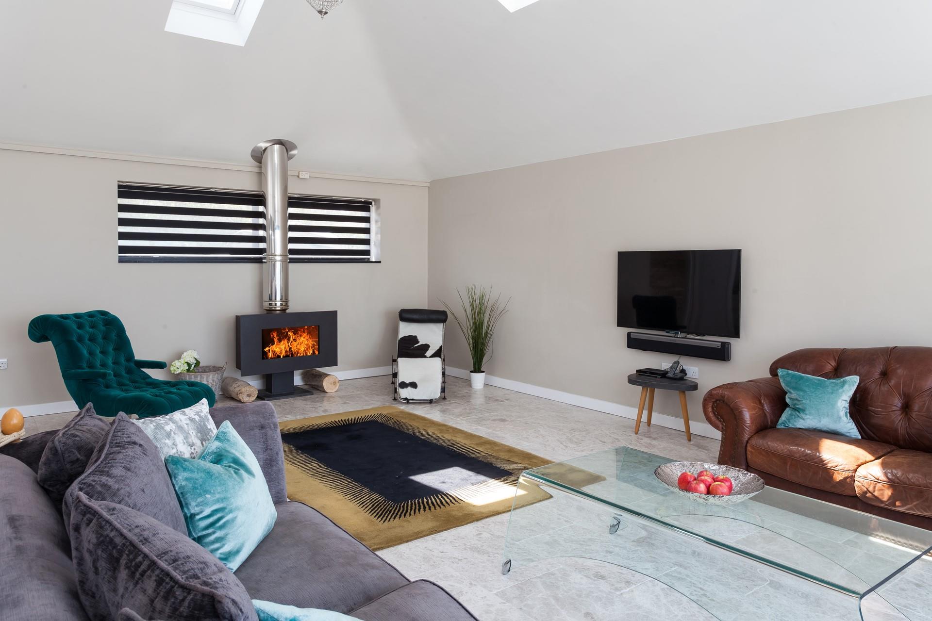 Light the contemporary woodburner and sink into relaxation mode.