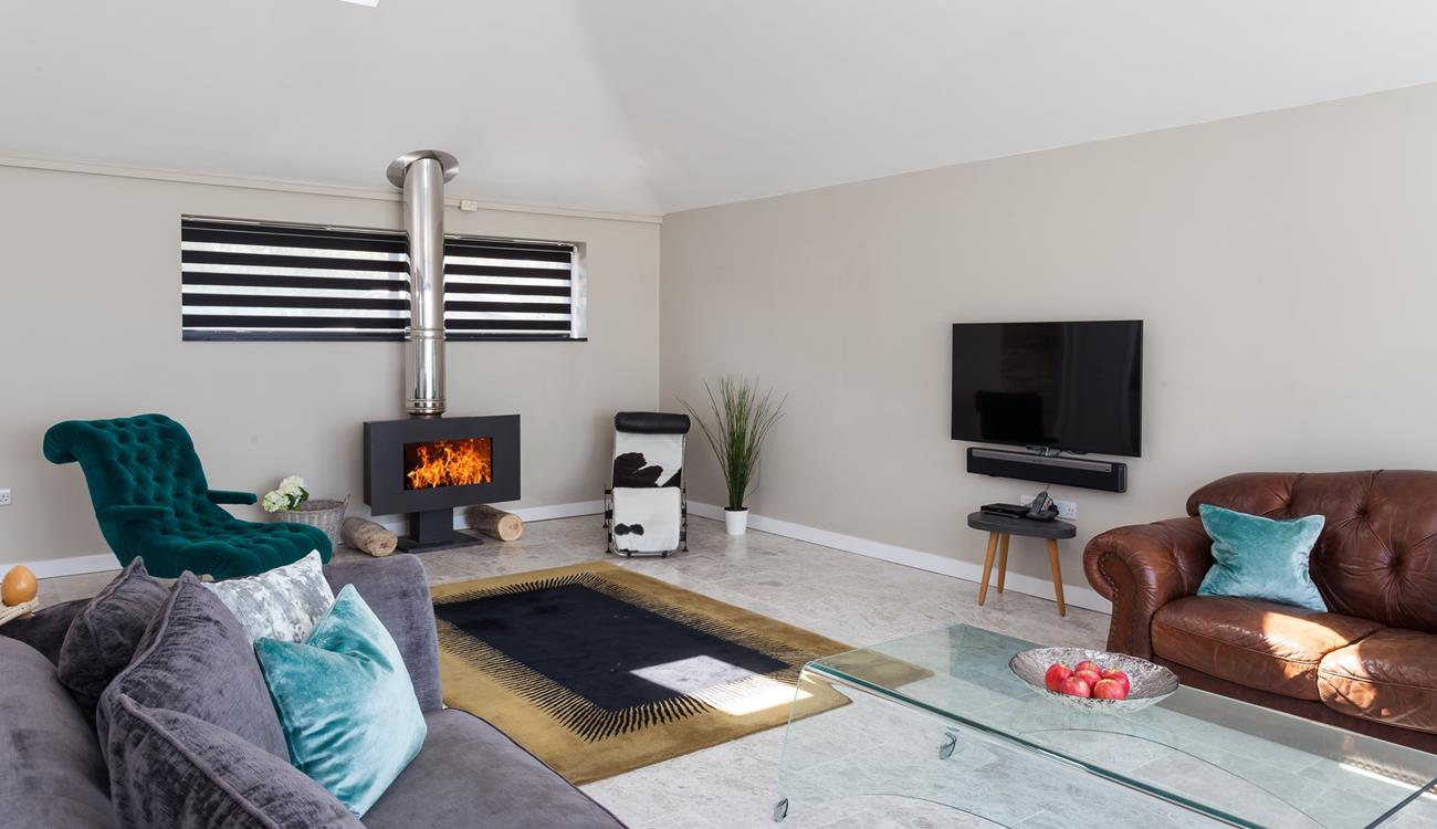 Light the contemporary woodburner and sink into relaxation mode.