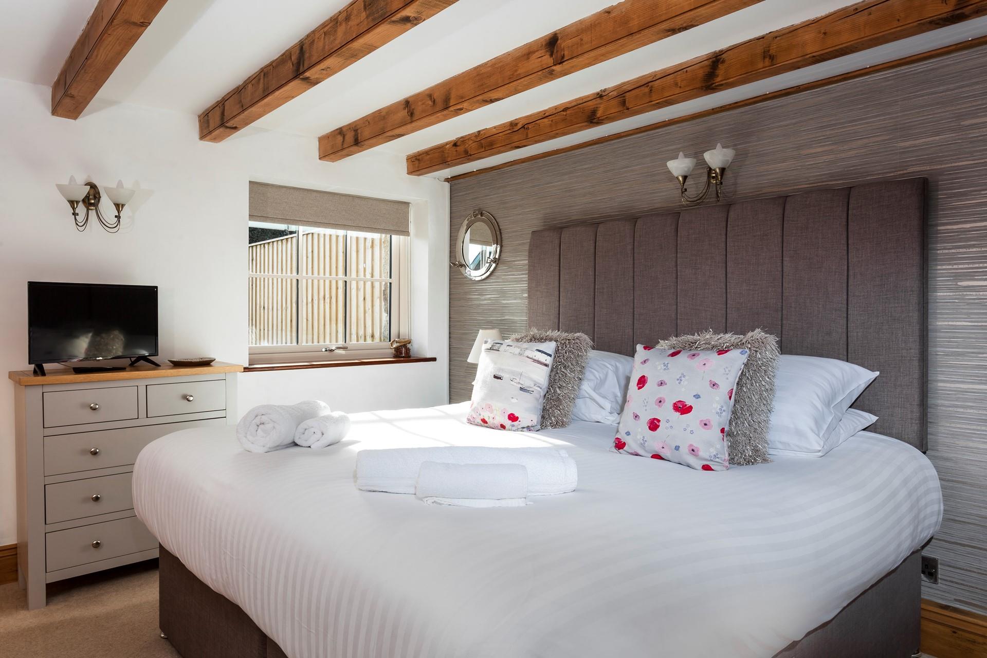 Every element of this stunning room has been designed with luxury and comfort in mind, ensuring a blissful night's sleep. 