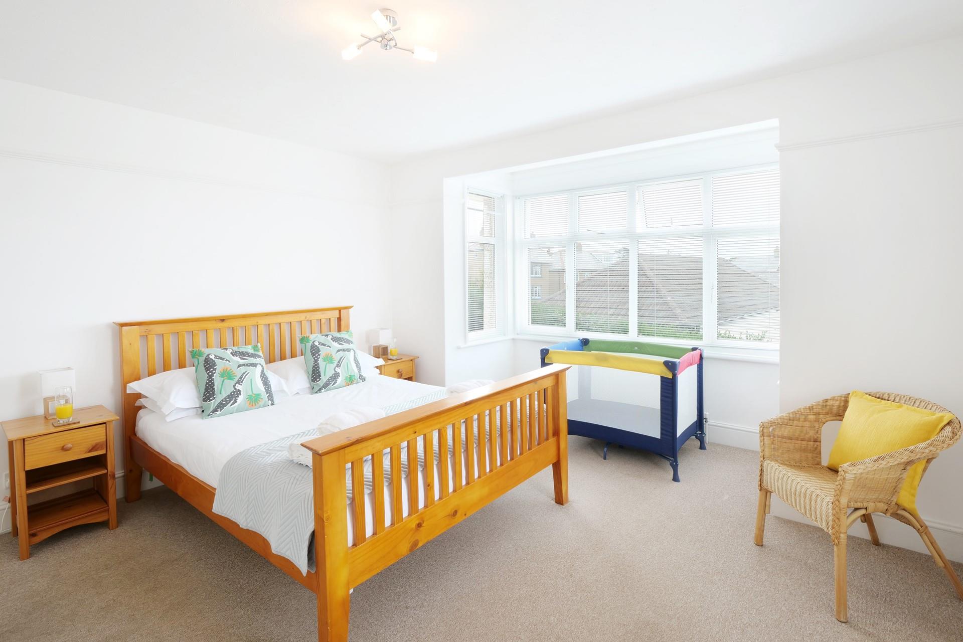 The main bedroom is spacious and light with plenty of space for a travel cot if required.