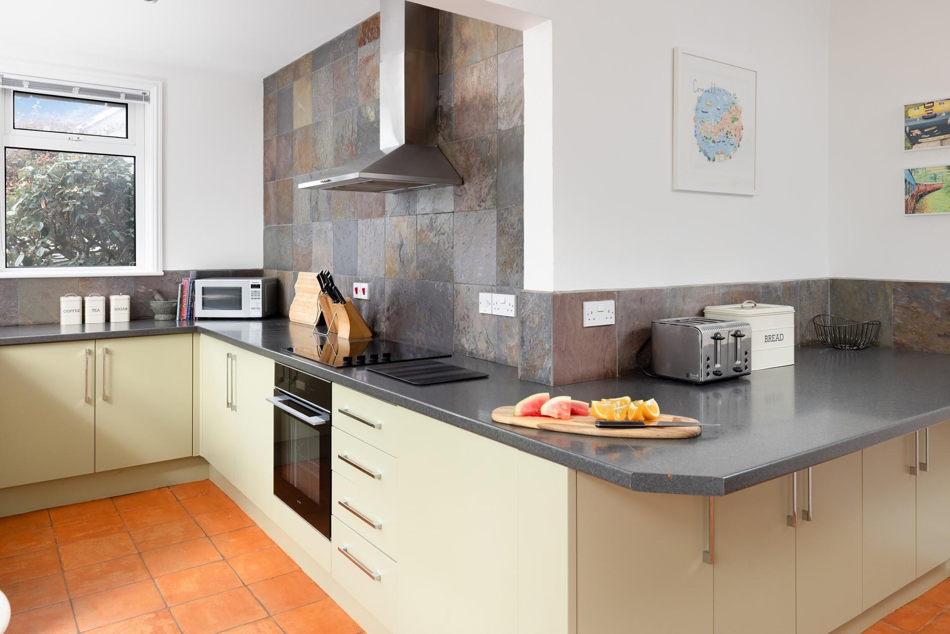 The kitchen is modern and fully equipped for cooking tasty feasts.