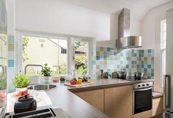 The bespoke kitchen overlooks the garden, so you can look out onto the pretty flower beds whilst preparing dinner. 