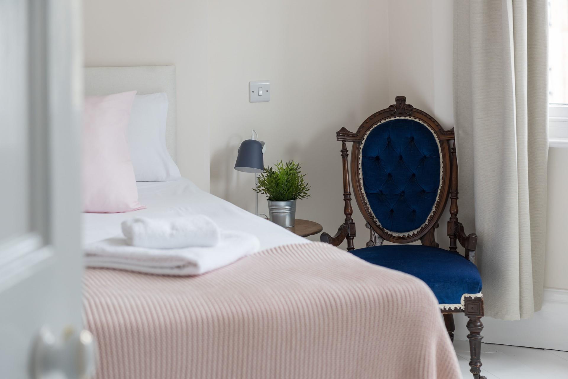 Bedroom 1 is on the ground floor and decorated in pretty pastel tones with a touch of Victorian class.