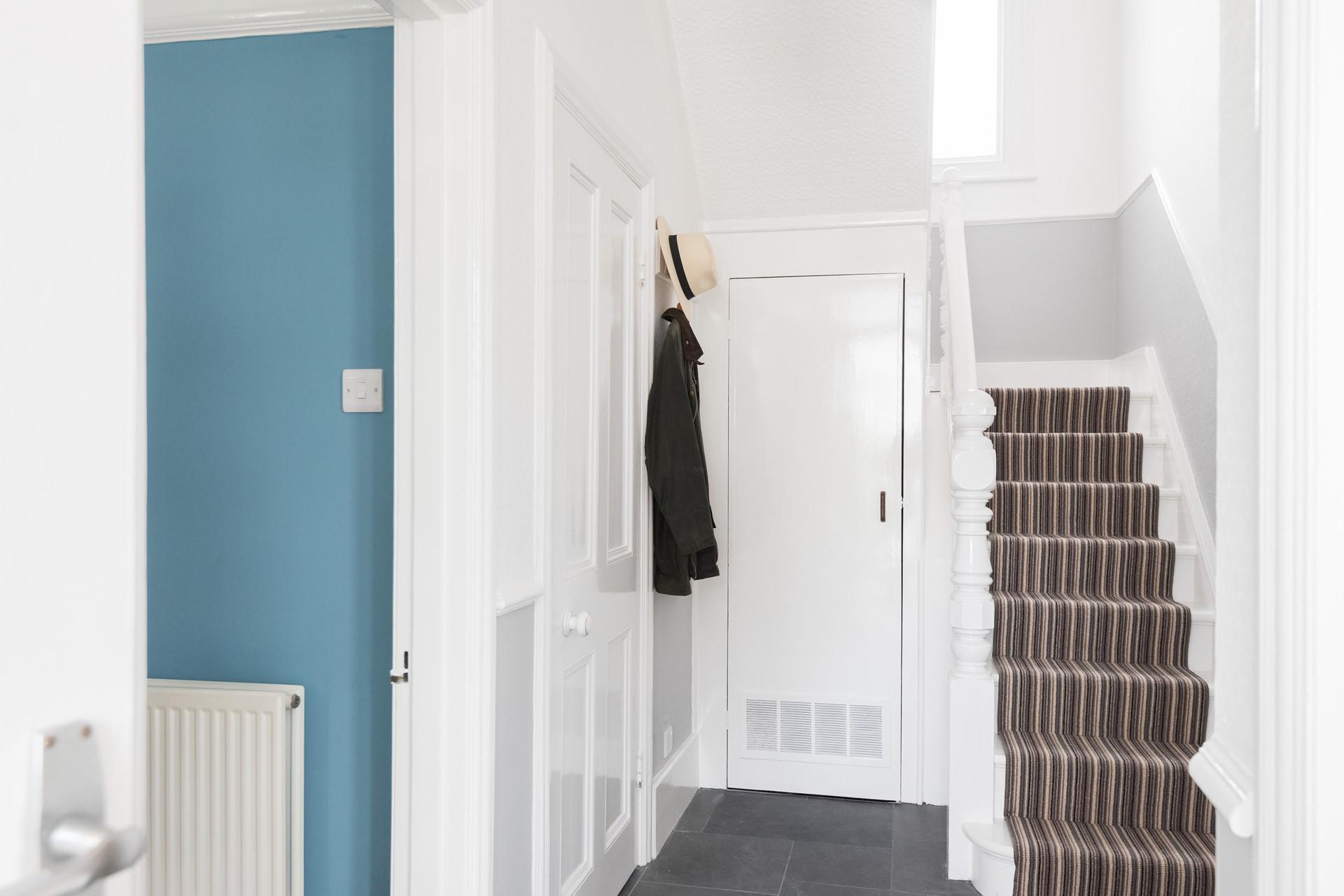 From the hallway, the stairs lead to the first floor and three of the four bedrooms. 