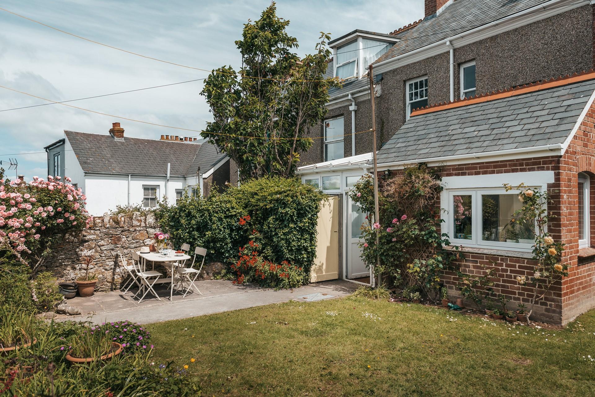 Climbing roses add to the houses elegance and grandeur. 