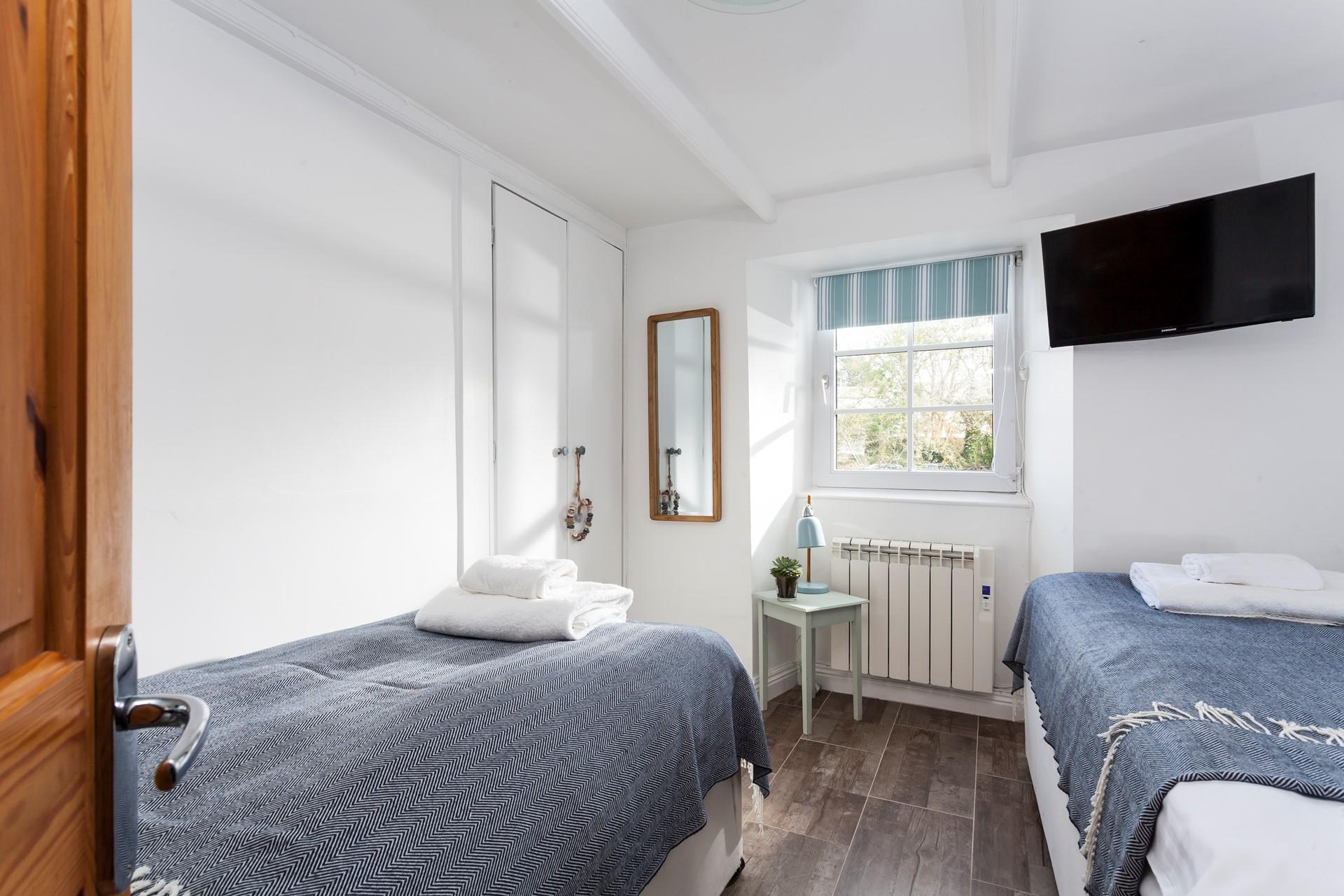 Bedroom 2 has twin beds perfect for kids or adults to tuck into.