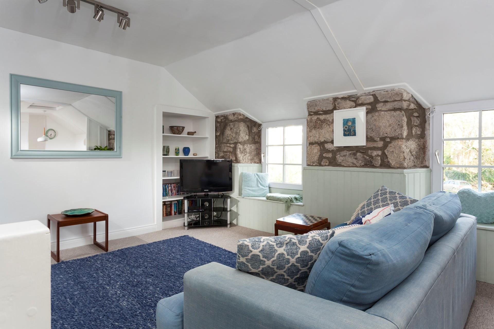 The sitting room has a lovely window spot- the perfect reading spot.