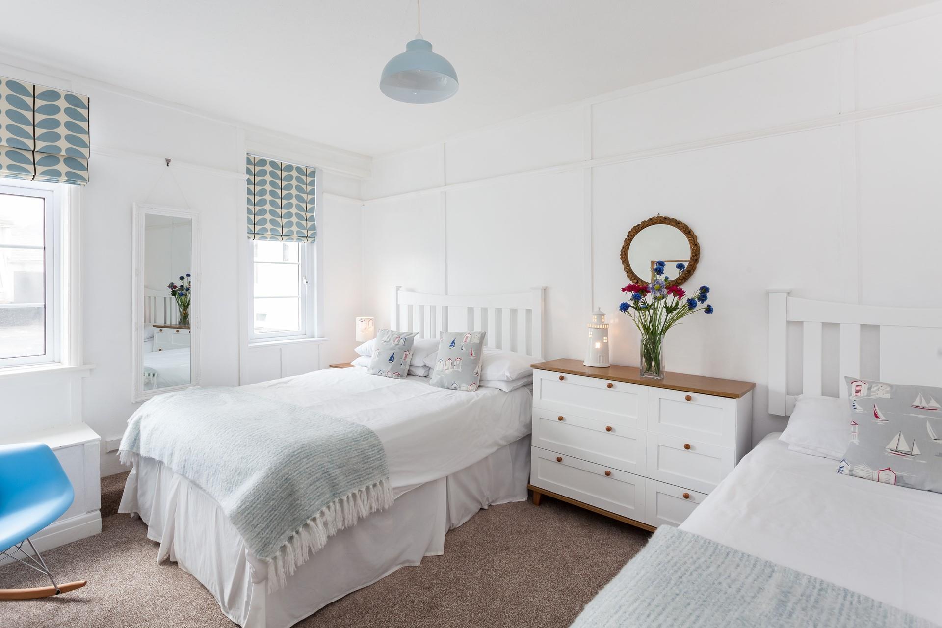 Spacious and serene the twin bedroom is complimented with crisp bedding. 