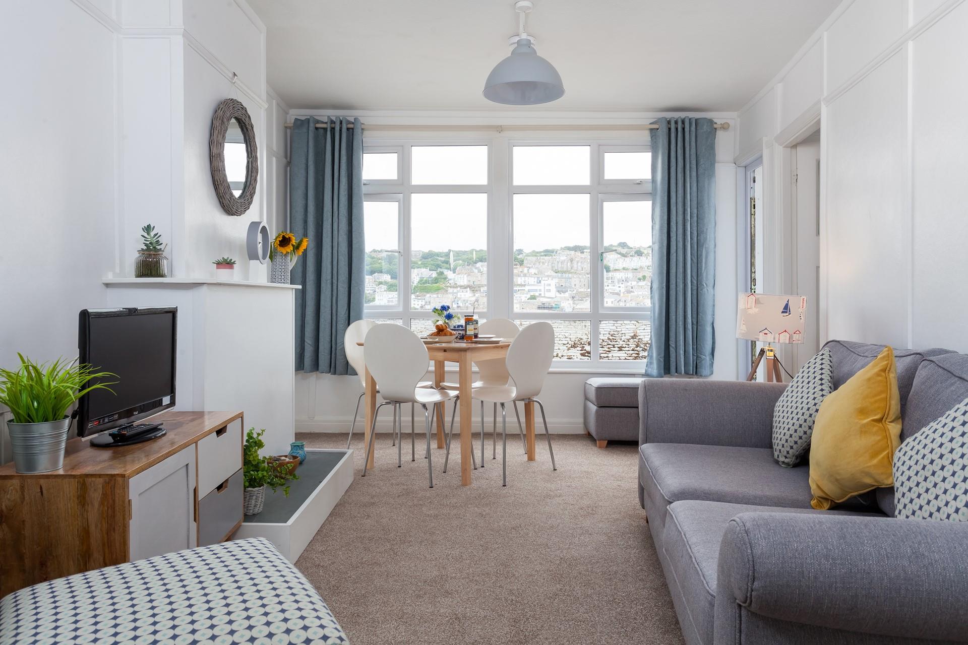 Relax in the cosy living room with views over the rooftops of St Ives.