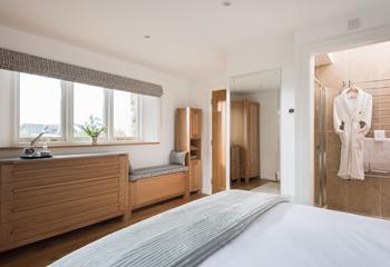 Spacious, light, and airy, the bedroom features bespoke, built-in furniture. 