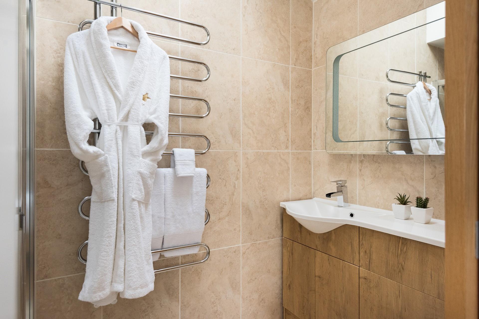 Modern and stylish, the en suite features a large walk-in shower. 