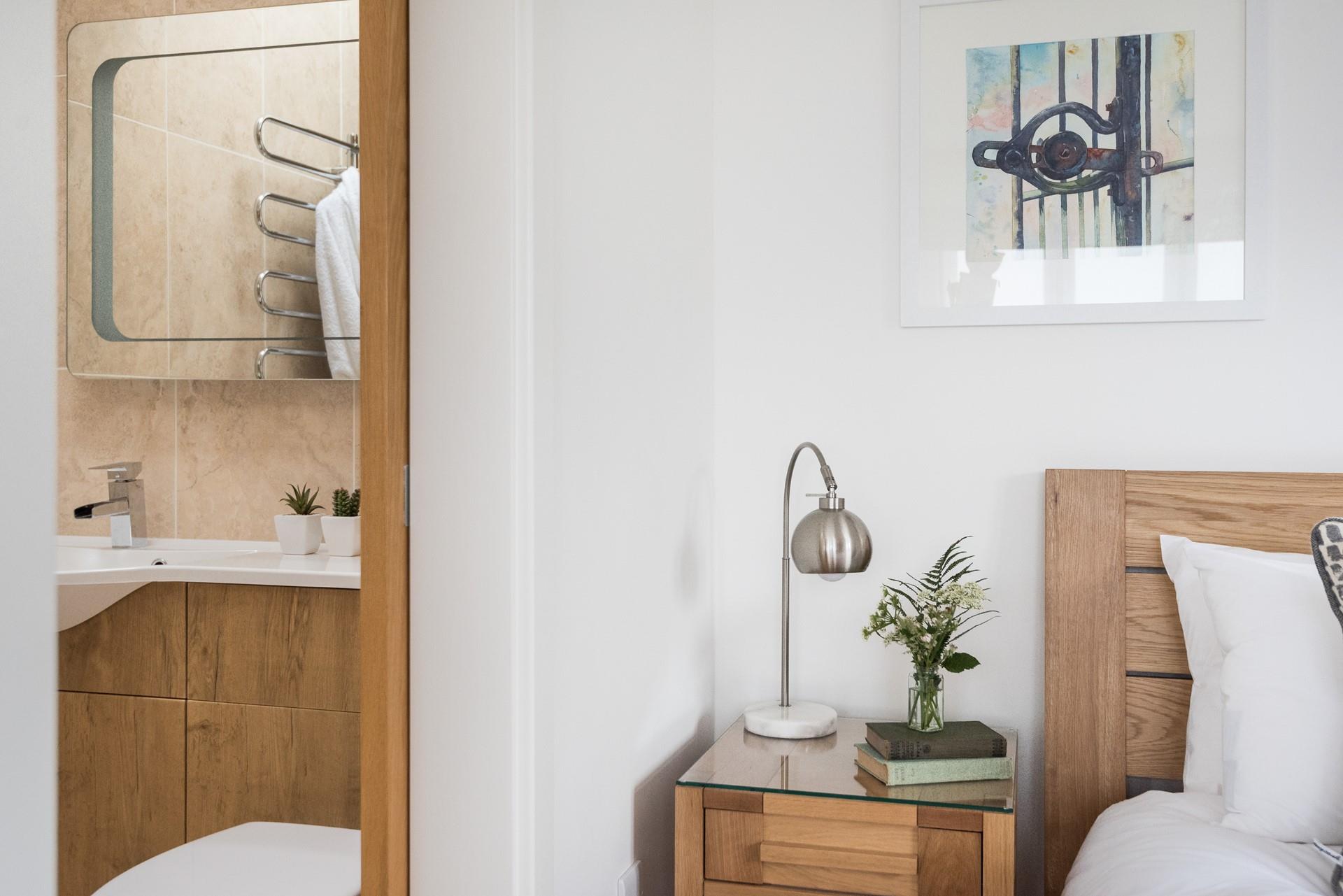 The en suite is accessed via the sliding wooden door. 