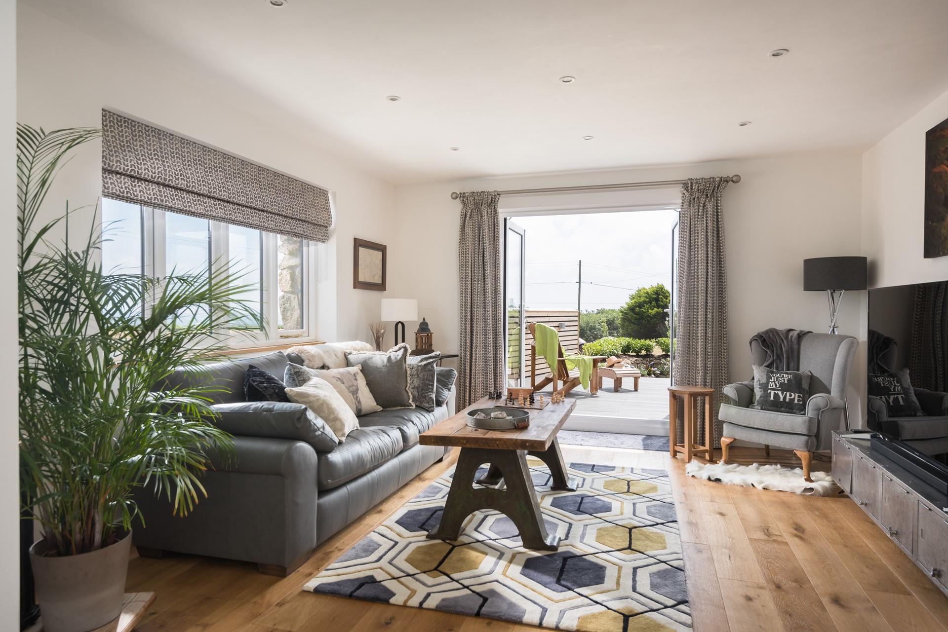Beautifully designed, the living area maximises space with doors leading to the decking. 