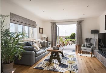Beautifully designed, the living area maximises space with doors leading to the decking. 