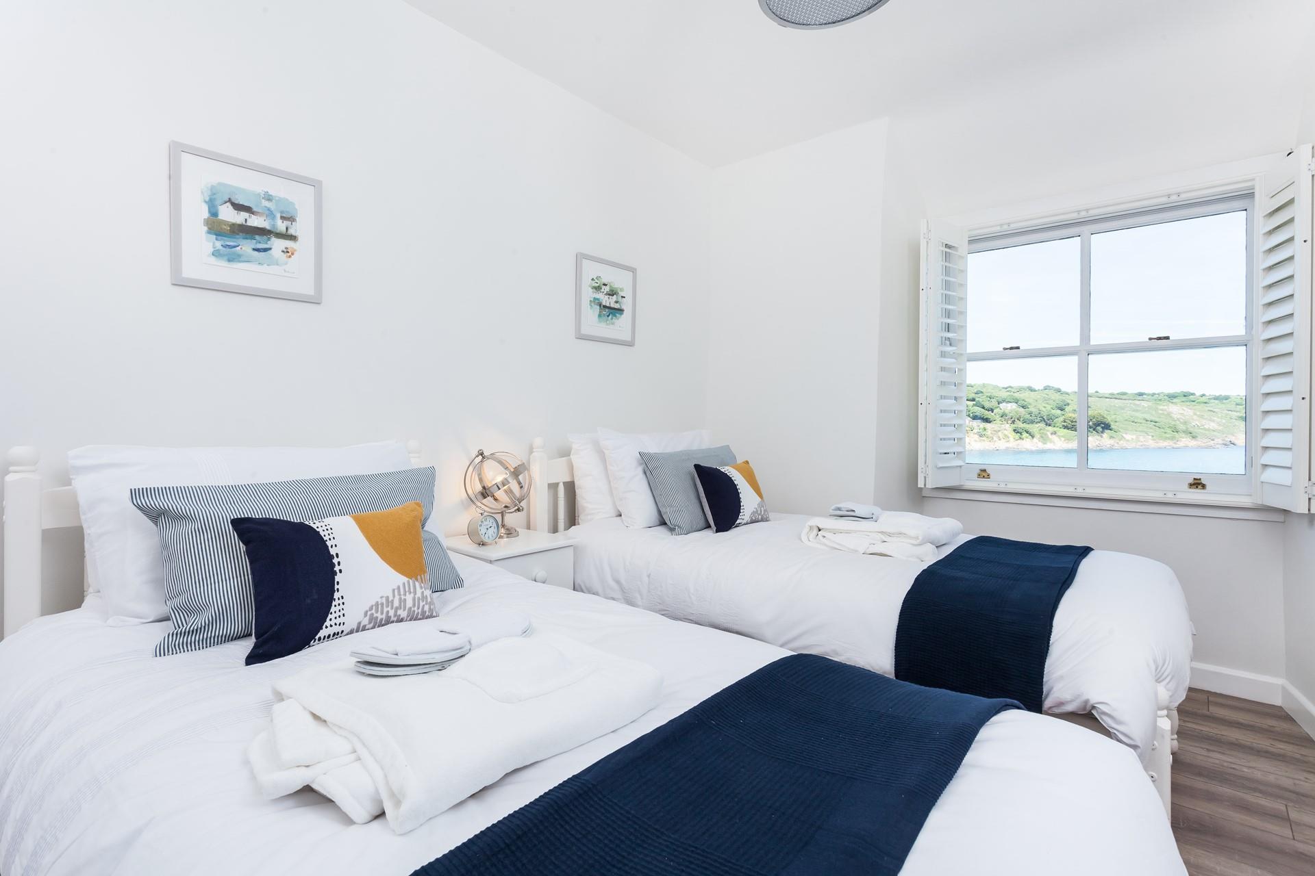 The twin room reminds you just how close you are to the sea with its seaside-themed tones and pretty coastal decor.