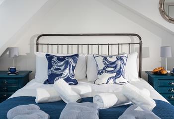 The calming blue and white tones with the seaside-inspired furniture create a perfect base to rest your head at night.