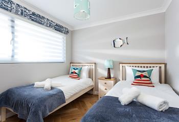 Bedroom 1 has twin beds, with super soft throws and a superb sea view.