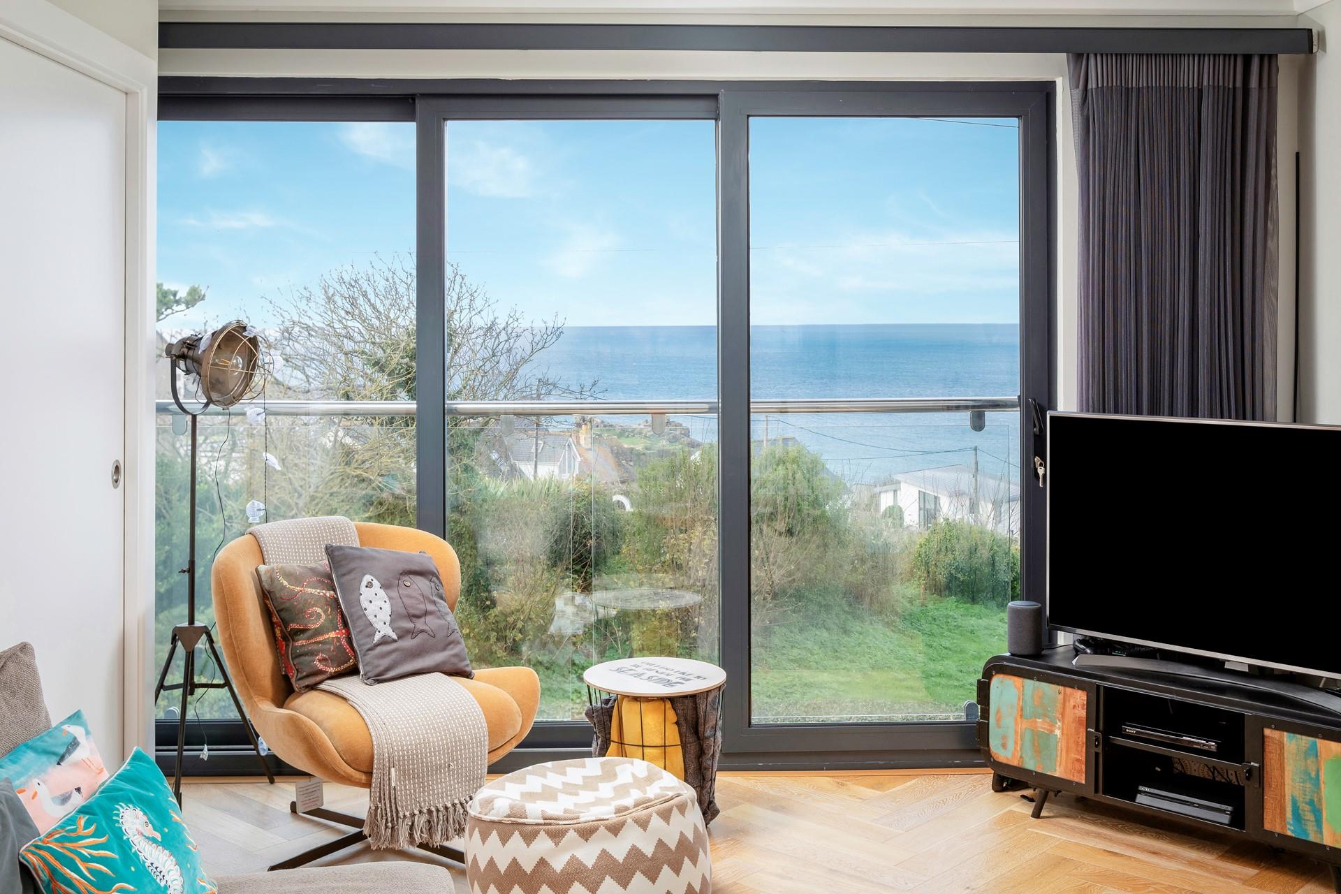 The living room has fantastic views over Porthmeor, you can slide open the sliding doors to reveal a private Juliette balcony and let the sea air in.