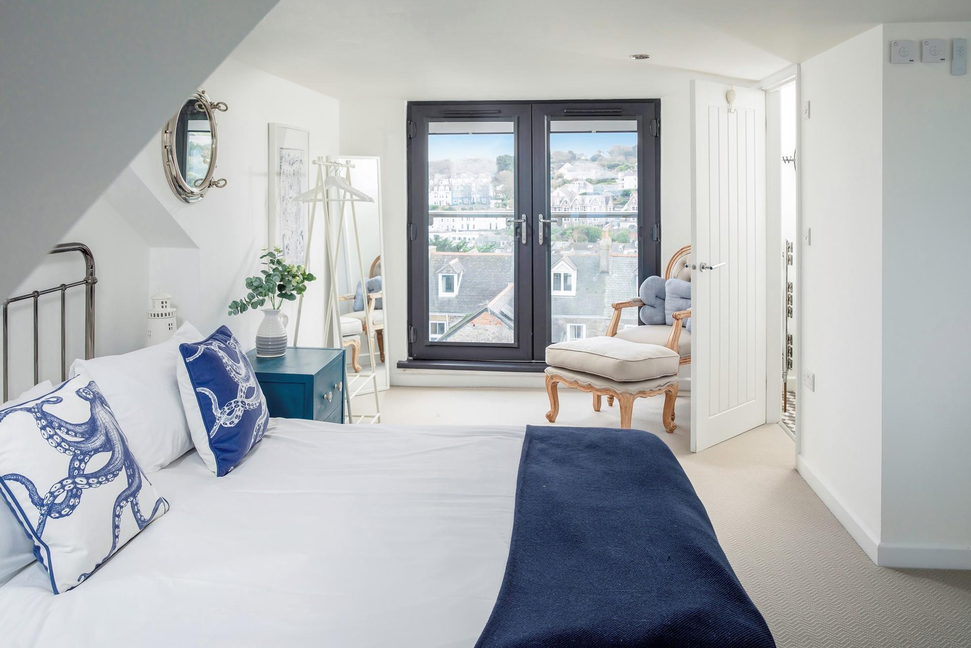 Bedroom 3 has a lovely king size bed on a painted iron frame, the room is well-sized, light and airy.