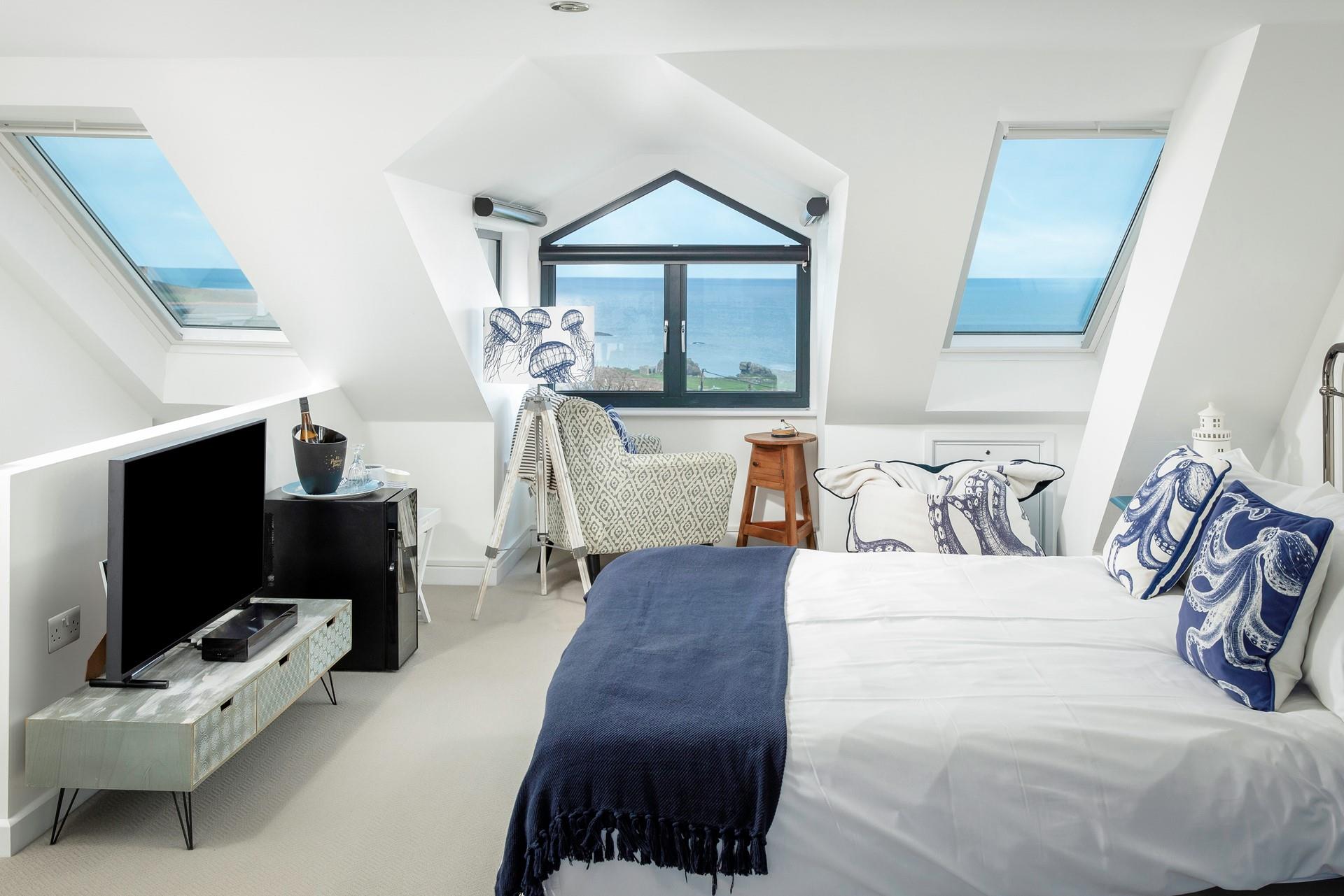 The calming blue and white tones with the seaside-inspired furniture create a perfect base to rest your head at night.