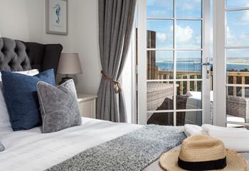 Elegant and chic, the bedroom has a king size bed and double French doors leading onto the private decking. 
