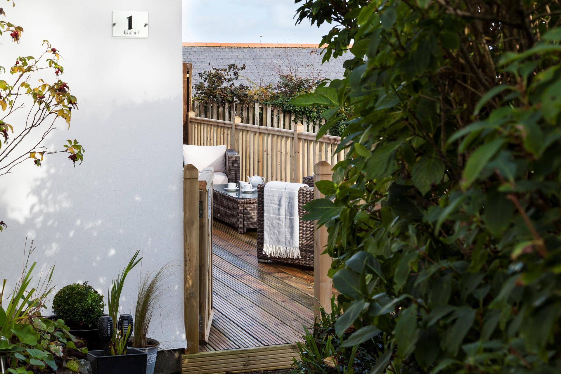 Enjoy dining alfresco on the private decking area, complete with comfortable rattan furniture. 