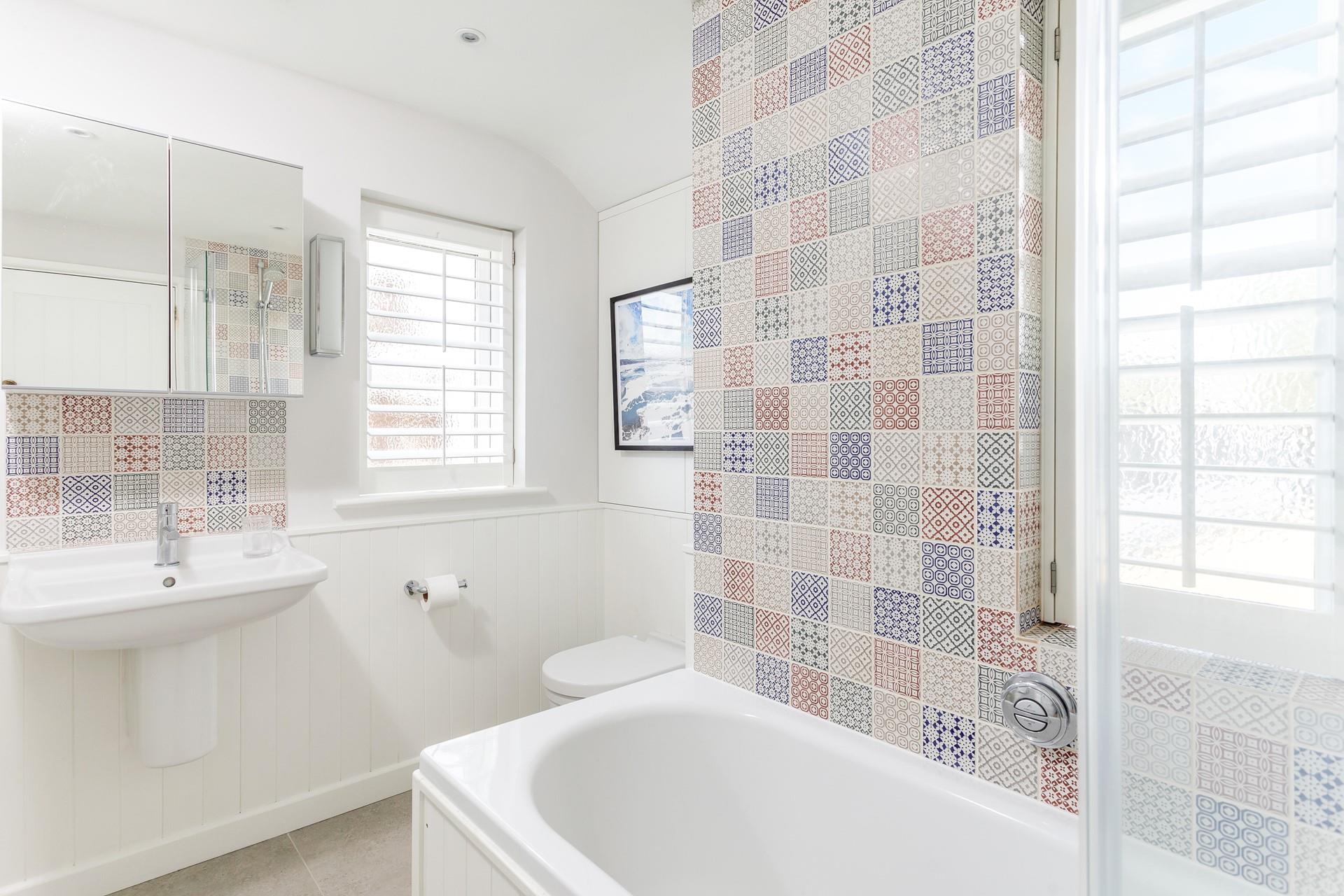 The colourful family bathroom benefits from little touches of luxury such as underfloor heating.