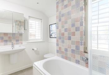 The colourful family bathroom benefits from little touches of luxury such as underfloor heating.