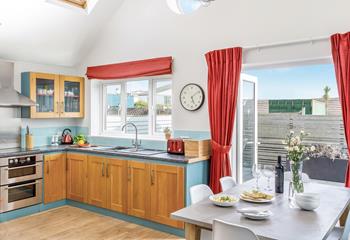 The gorgeous kitchen with its blue hues is well-equipped and benefits from sea views so you can even enjoy the waves whilst cooking!