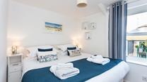 Bedroom 1 has zip and link beds, offering guests flexible sleeping arrangements.