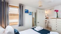 Bedroom 2 benefits from an en suite bathroom, providing additional space to get ready for the day.