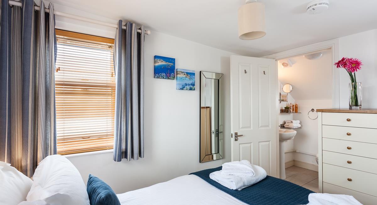 Bedroom 2 benefits from an en suite bathroom, providing additional space to get ready for the day.