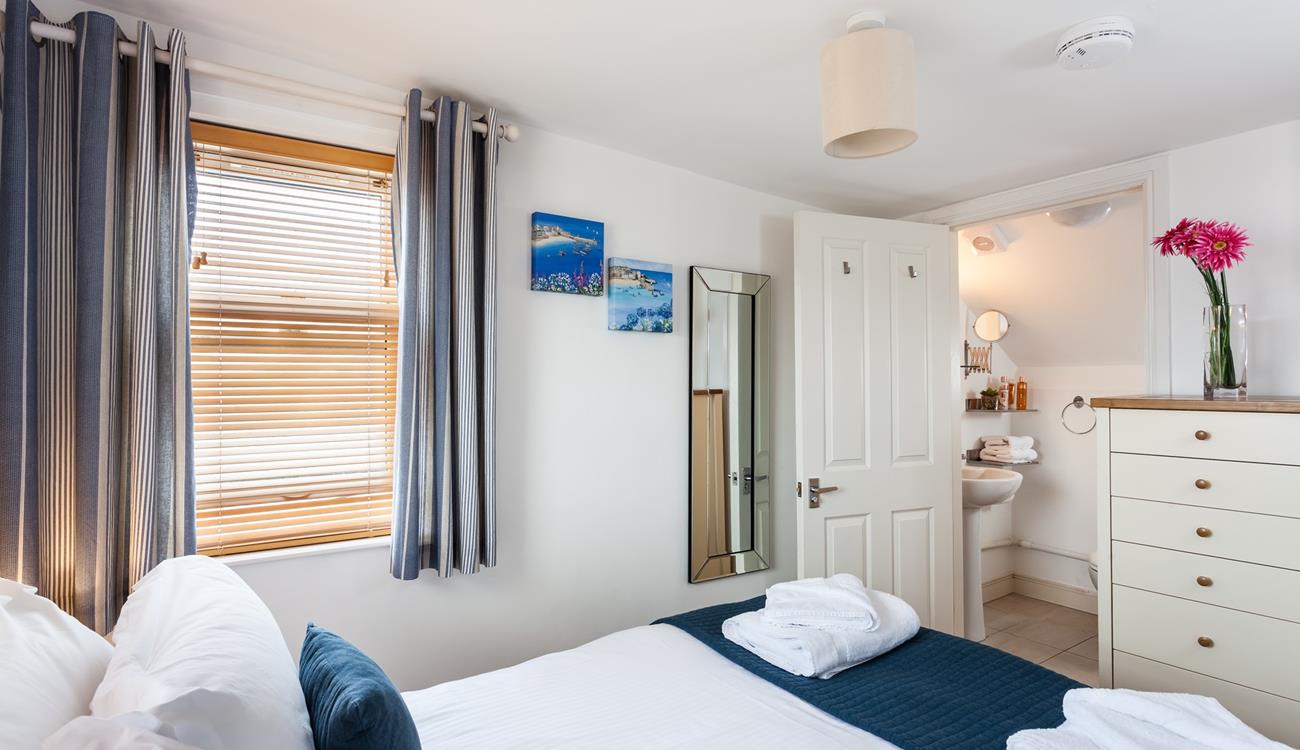 Bedroom 2 benefits from an en suite bathroom, providing additional space to get ready for the day.