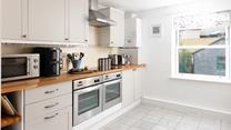 The kitchen is well-equipped with modern appliances to cook up a feast.