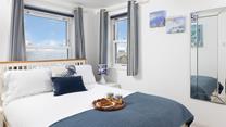 Seaside blue tones create a calming space to relax each evening.