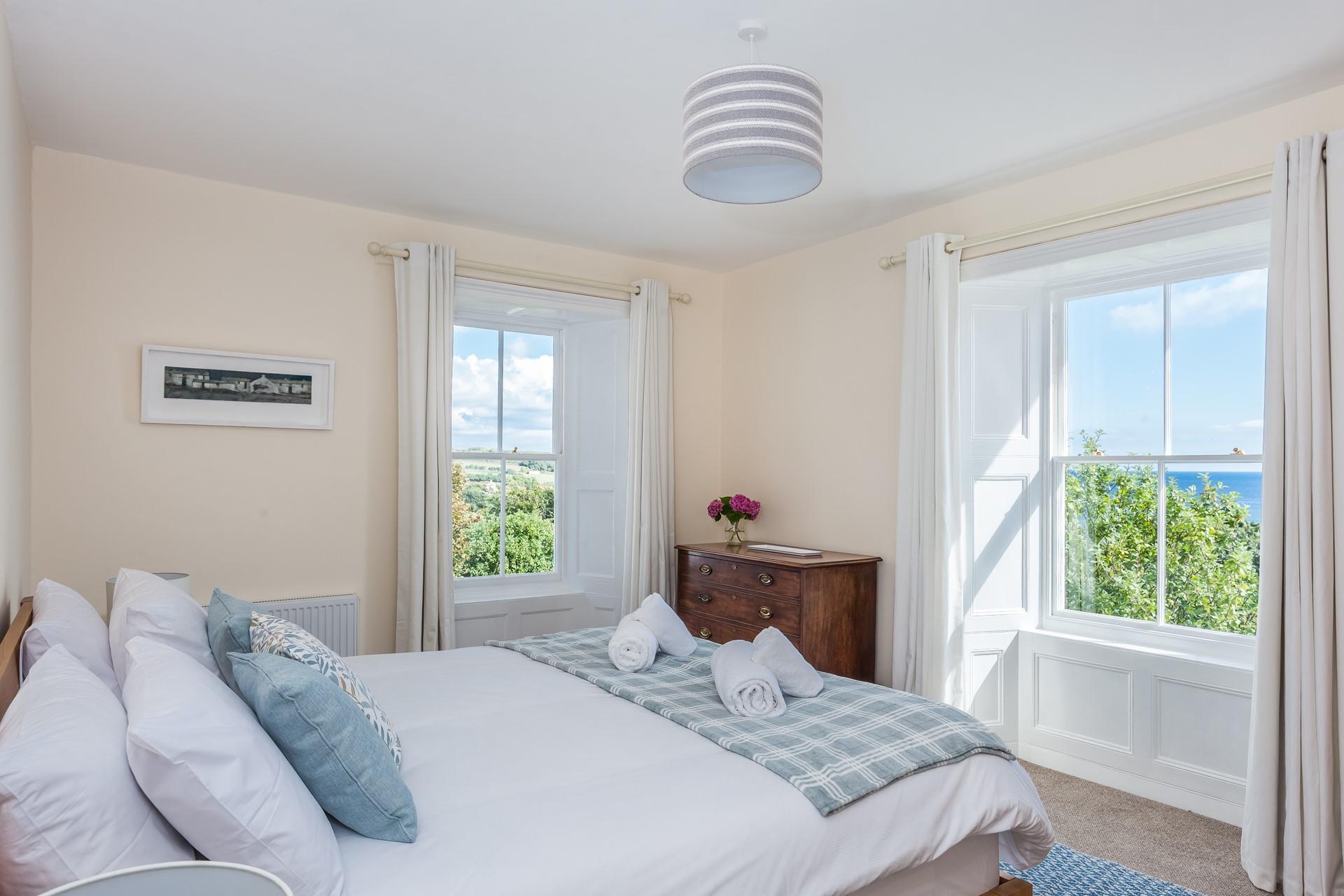 Bedroom 5 has dual aspect sea and rural views, and a super king size bed. 