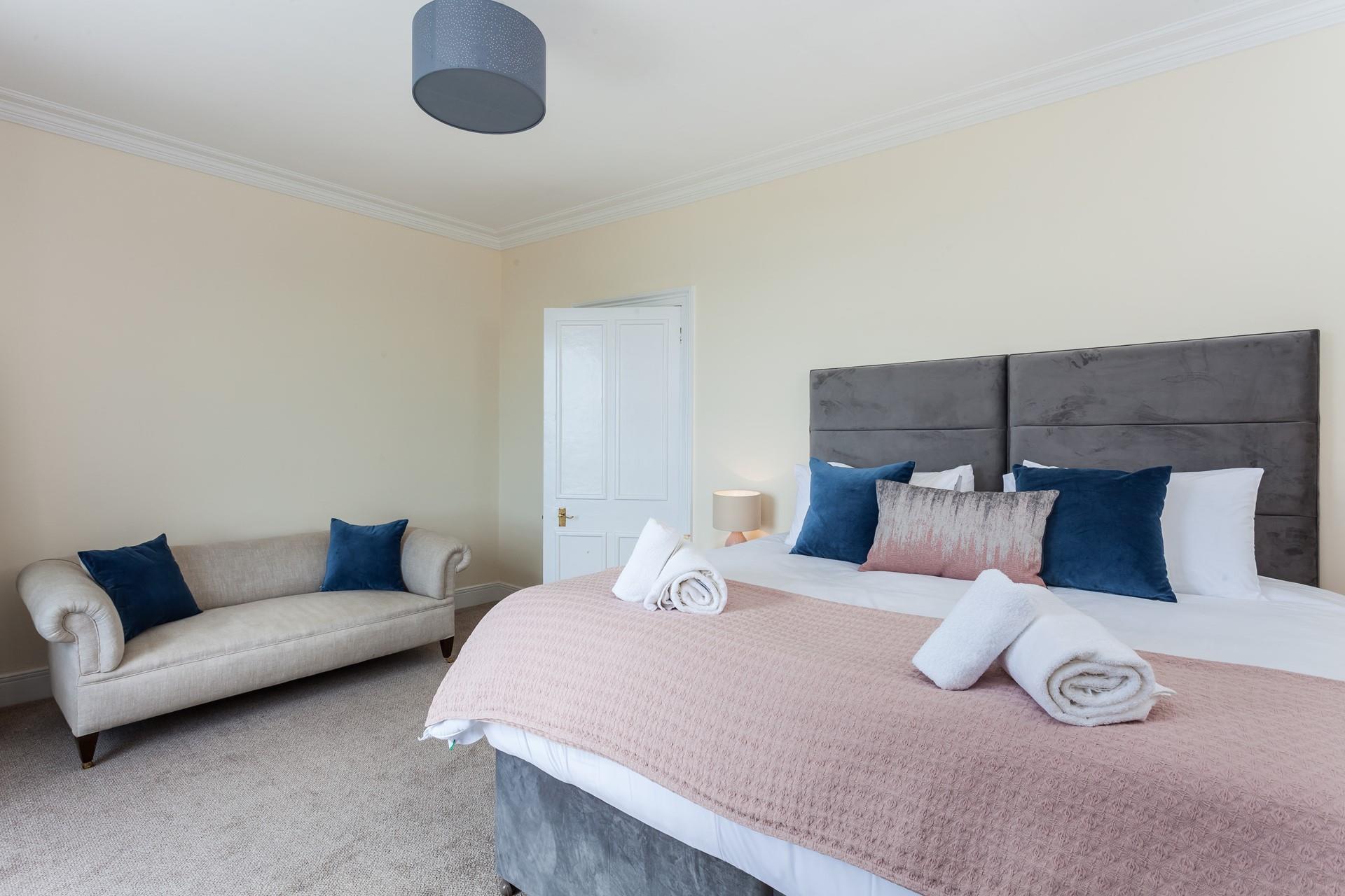 Bedroom 4 is a spacious room with a sofa. 