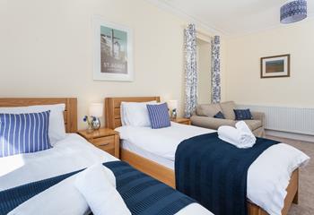 The spacious twin room has a sofa and large TV; perfect for the kids.