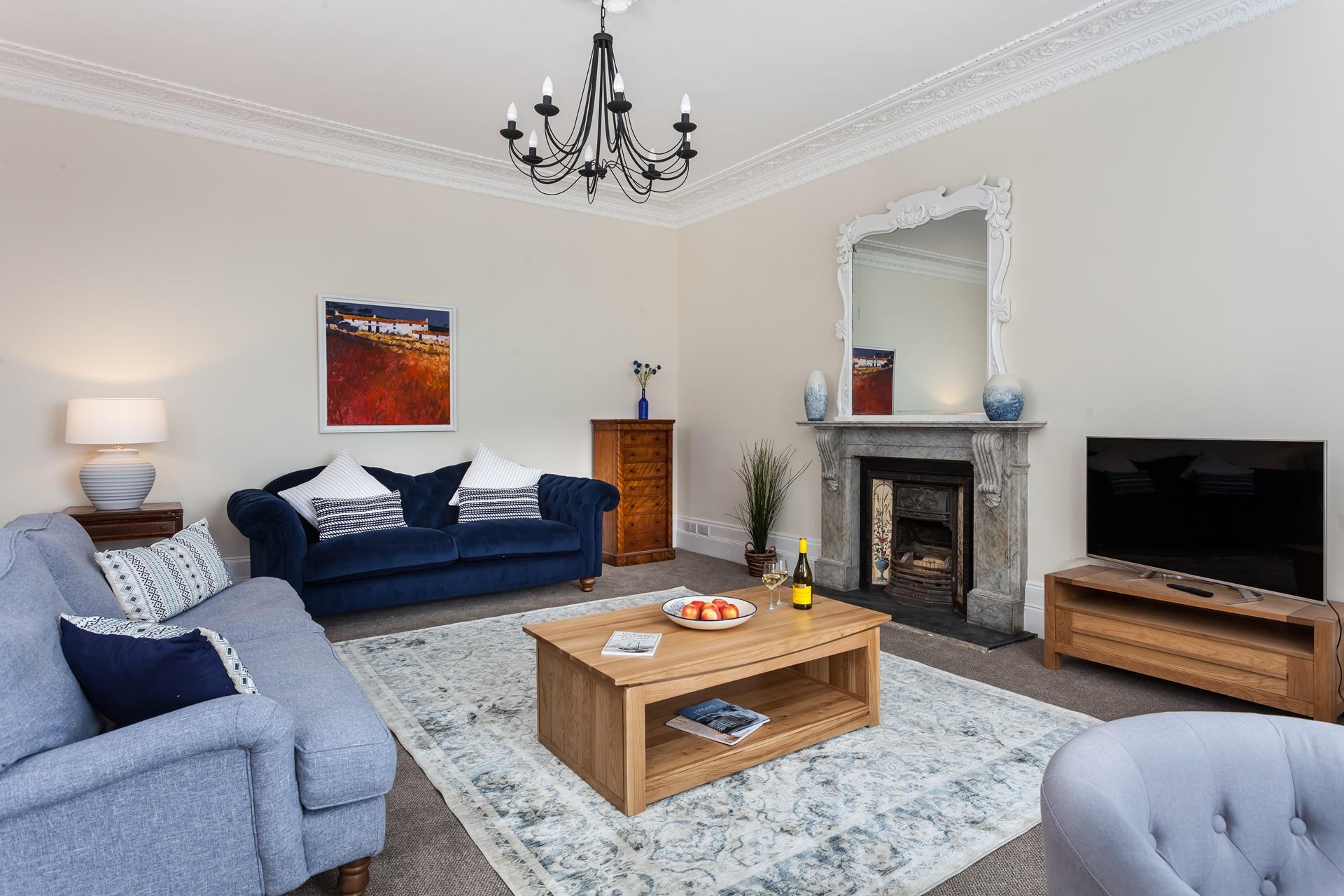 The plush sitting room is spacious enough for the whole party to gather for an evening together. 