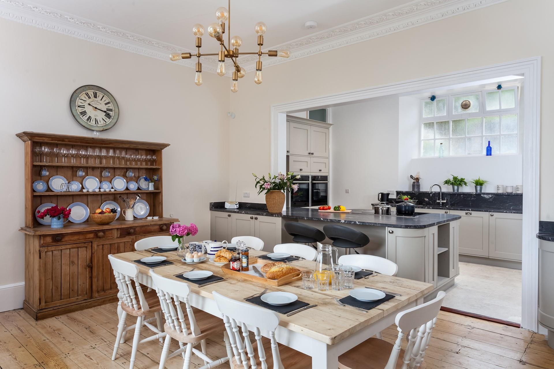 Traditional farmhouse style meets modern amenities in the open plan kitchen and dining space.